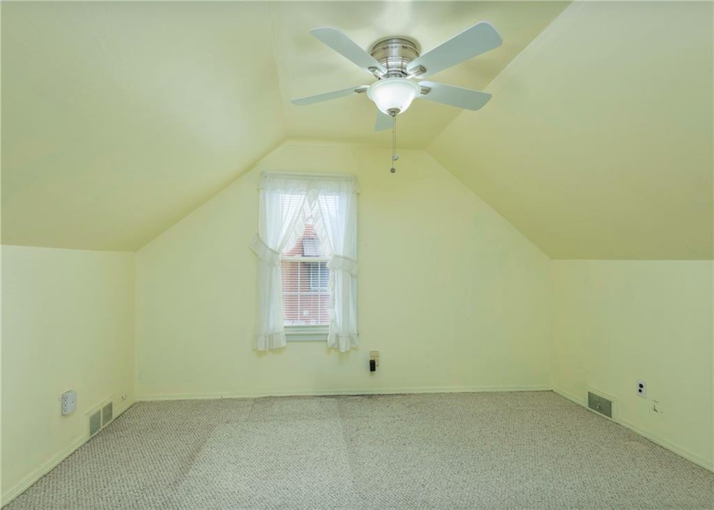 115 Rockwood Street Monroeville, PA 15146 - Photo 27 of 32 an empty room with a chandelier fan and windows
