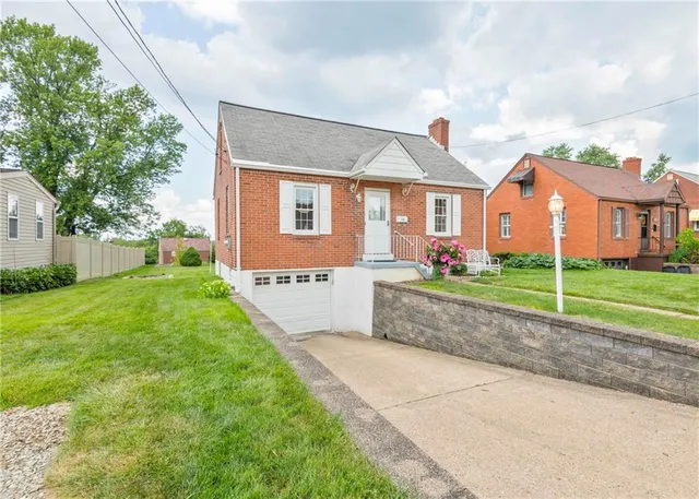 a front view of house with yard and green space