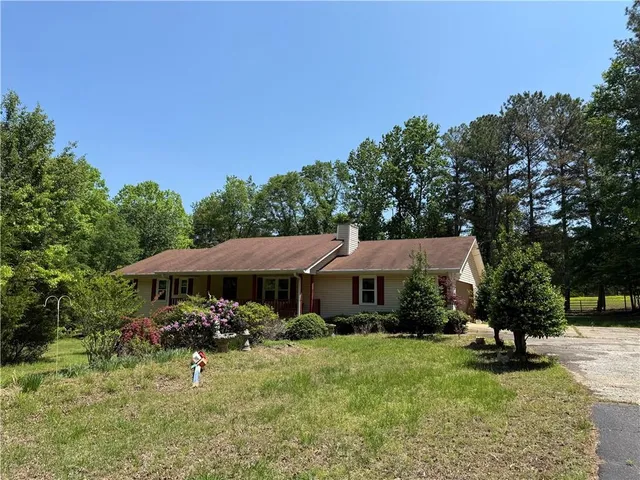 a view of a house with backyard and sitting area