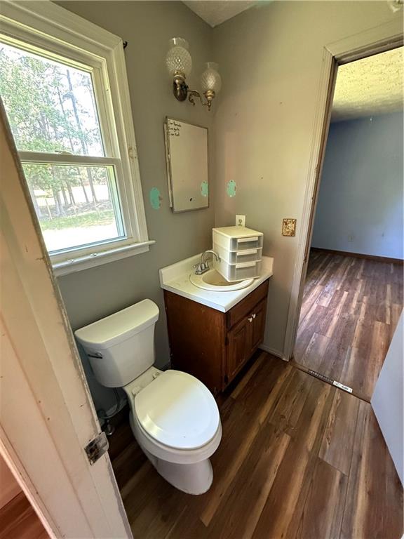 7260 Cox Road Cumming, GA 30028 - Photo 11 of 18 a bathroom with a toilet sink and mirror