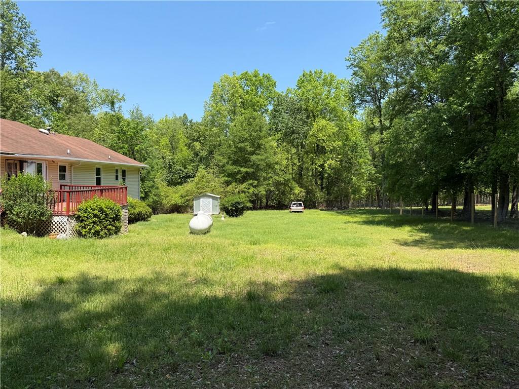 7260 Cox Road Cumming, GA 30028 - Photo 14 of 18 a backyard of a house with lots of green space and fountain