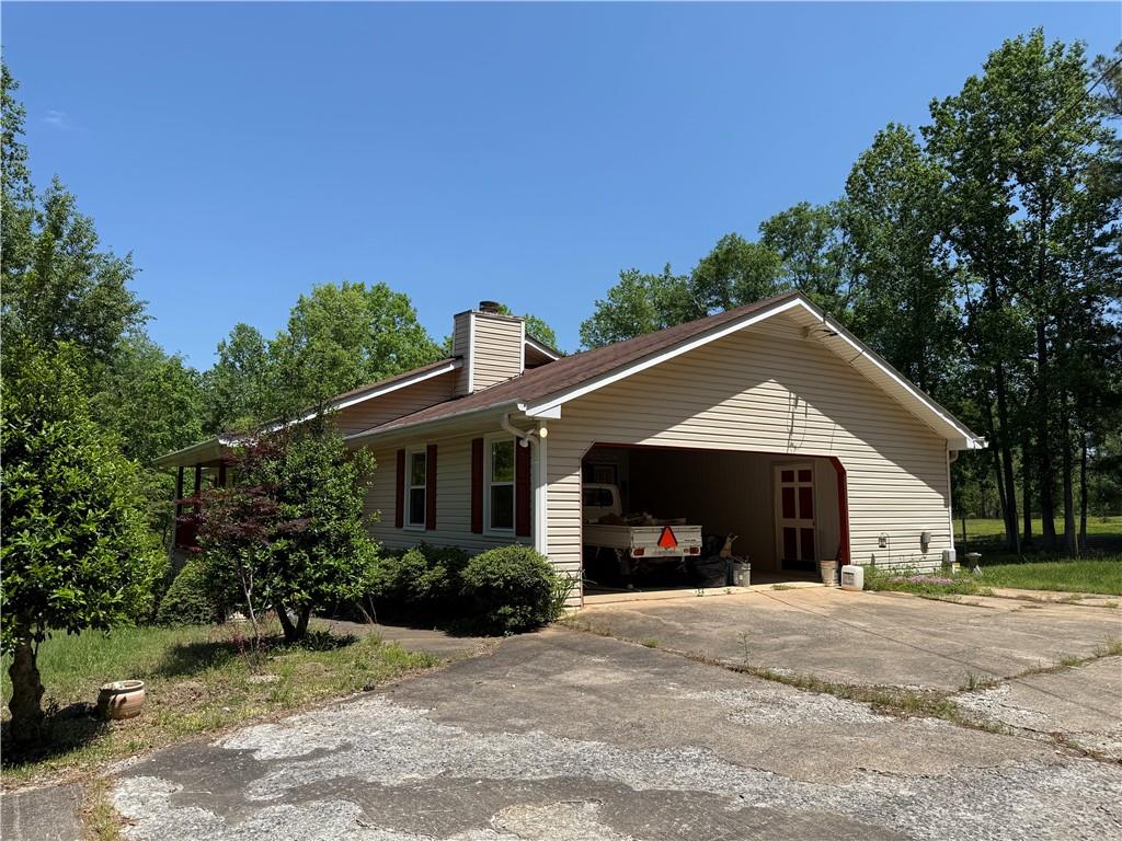 7260 Cox Road Cumming, GA 30028 - Photo 2 of 18 a front view of a house with a yard and garage