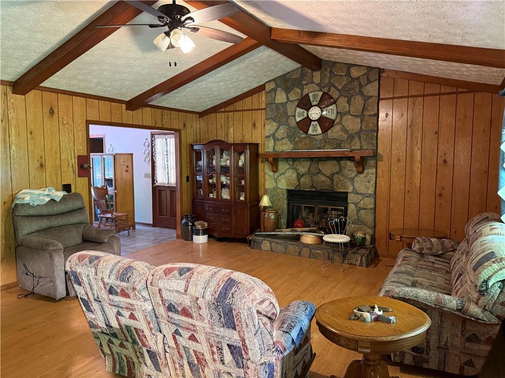 7260 Cox Road Cumming, GA 30028 - Photo 4 of 18 a living room with furniture a fireplace and a chandelier