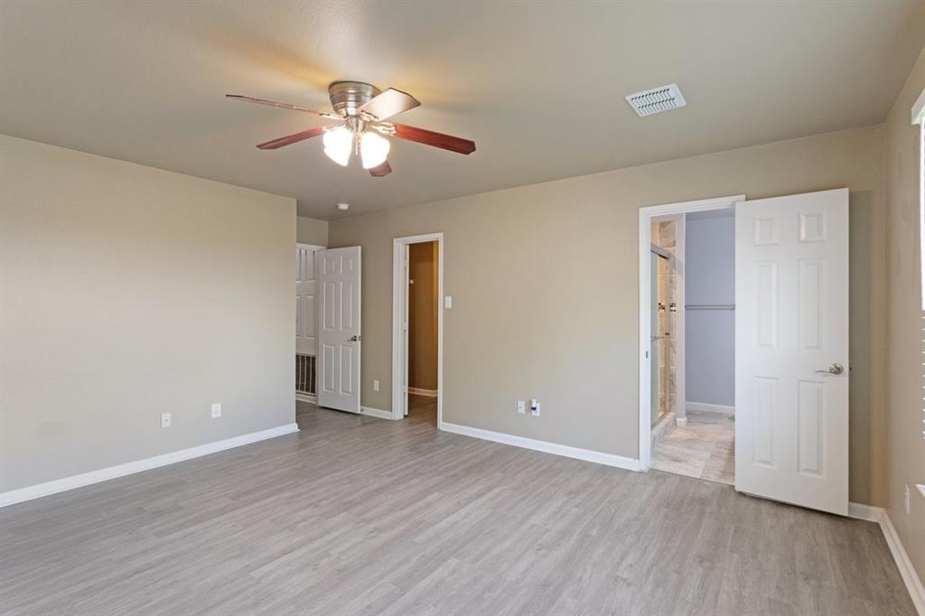 1005 Live Oak Drive Anna, TX 75409 - Photo 11 of 29 Unfurnished bedroom featuring light wood-type flooring, a ceiling fan, and ensuite bath