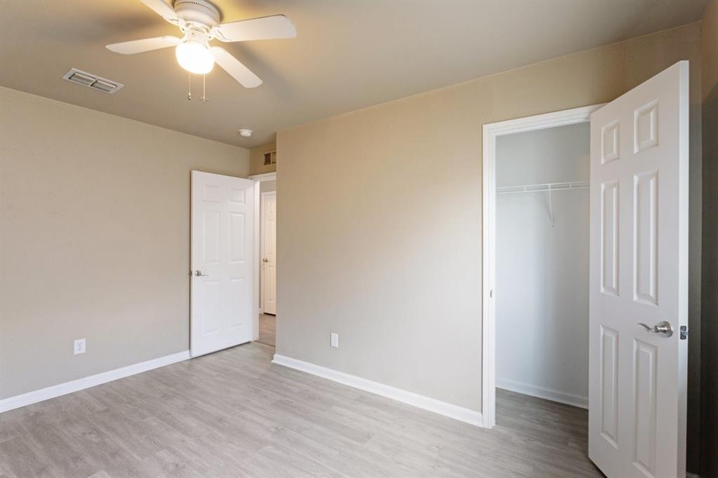 1005 Live Oak Drive Anna, TX 75409 - Photo 16 of 29 Unfurnished bedroom featuring light wood-style flooring, a ceiling fan, and a spacious closet