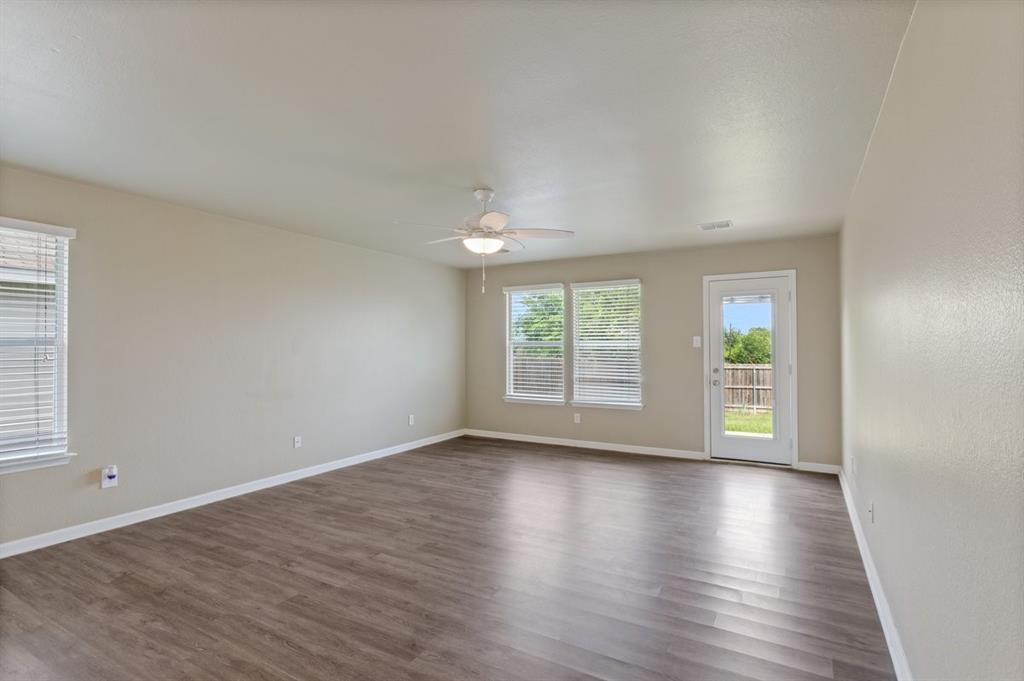 1005 Live Oak Drive Anna, TX 75409 - Photo 18 of 29 Spare room with dark wood-style floors and ceiling fan