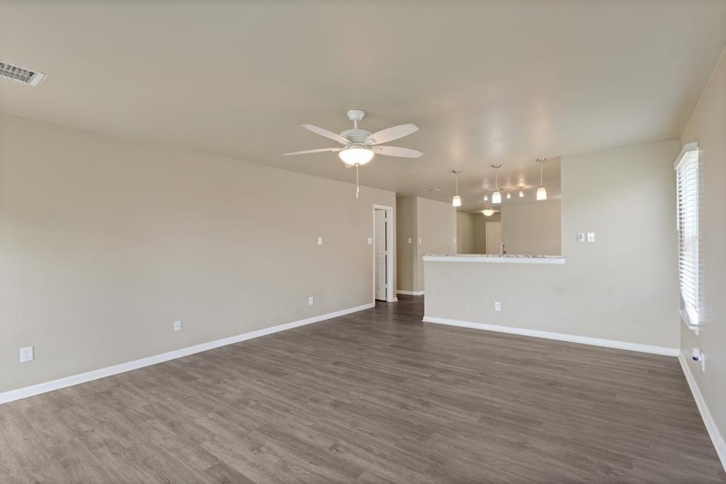 1005 Live Oak Drive Anna, TX 75409 - Photo 7 of 29 Unfurnished living room with dark wood finished floors and ceiling fan
