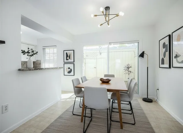 a view of a dining room with furniture and window