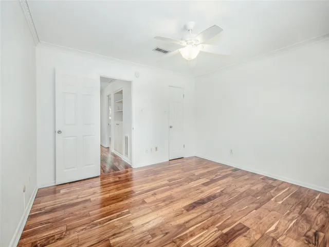 a view of a room with wooden floor and white walls