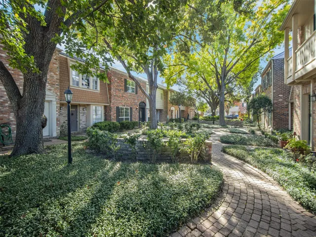 a view of backyard of house with green space
