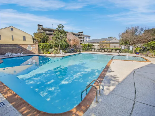 a view of a swimming pool with a yard