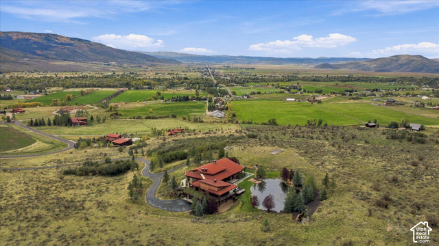 5936 Triple Crown Trail Oakley, UT 84055 - Photo 46 of 57 Extensive acreage with a private pond, mountainous backdrop, and winding driveway