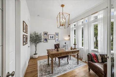 a living room with furniture and a chandelier
