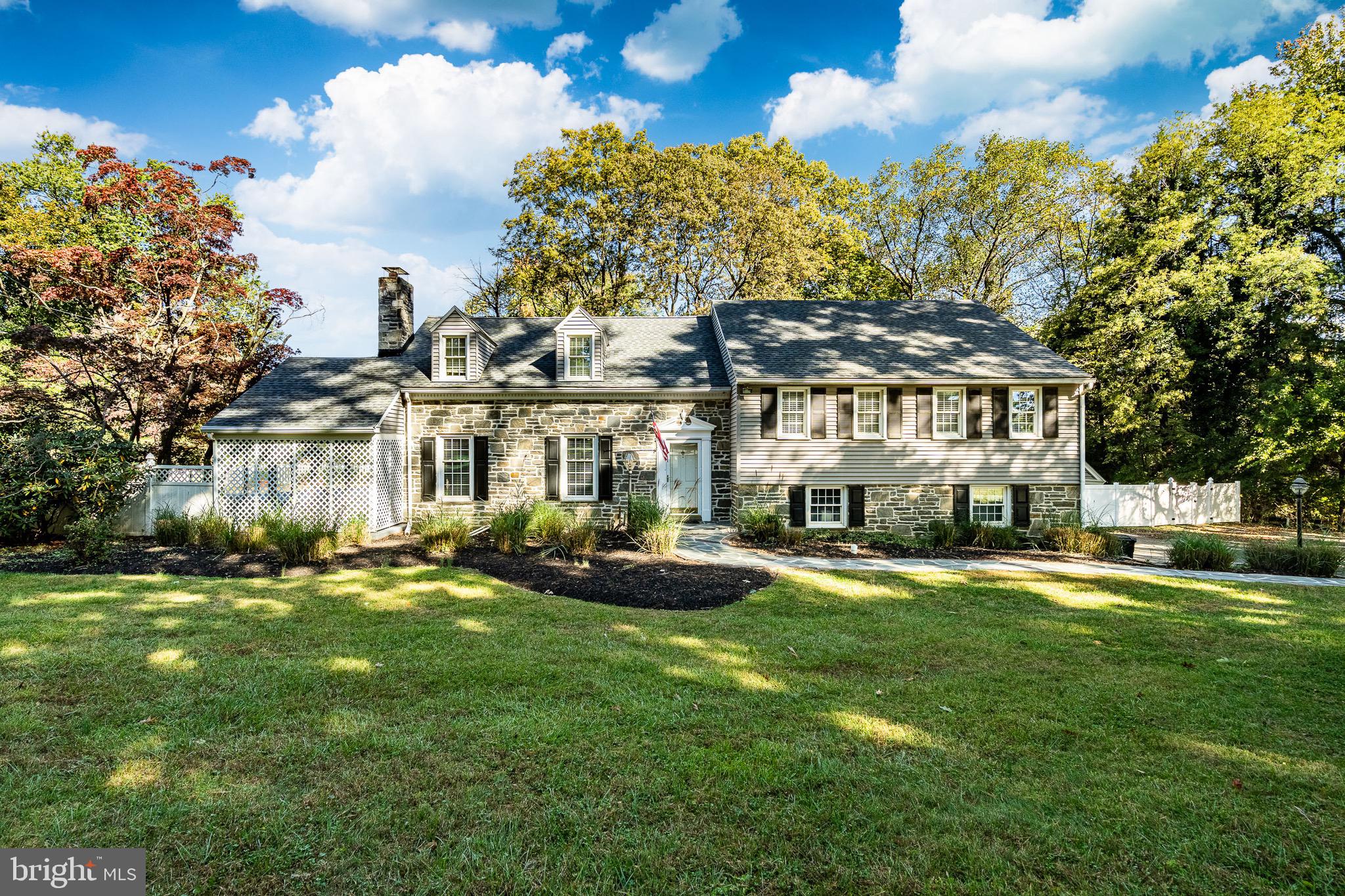 a front view of a building with a garden