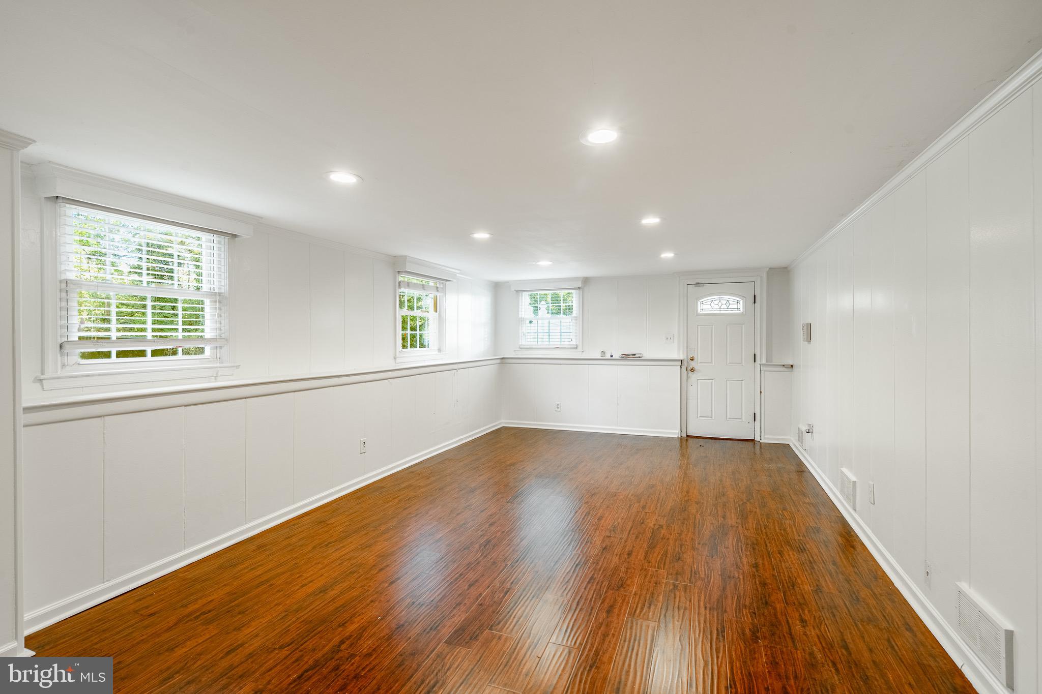 657 Walker Road Wayne, PA 19087 - Photo 11 of 66 an empty room with wooden floor and windows