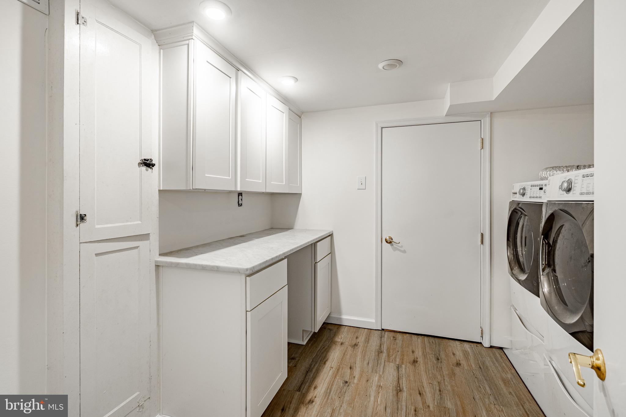 657 Walker Road Wayne, PA 19087 - Photo 17 of 66 a utility room with wooden floor washer and dryer