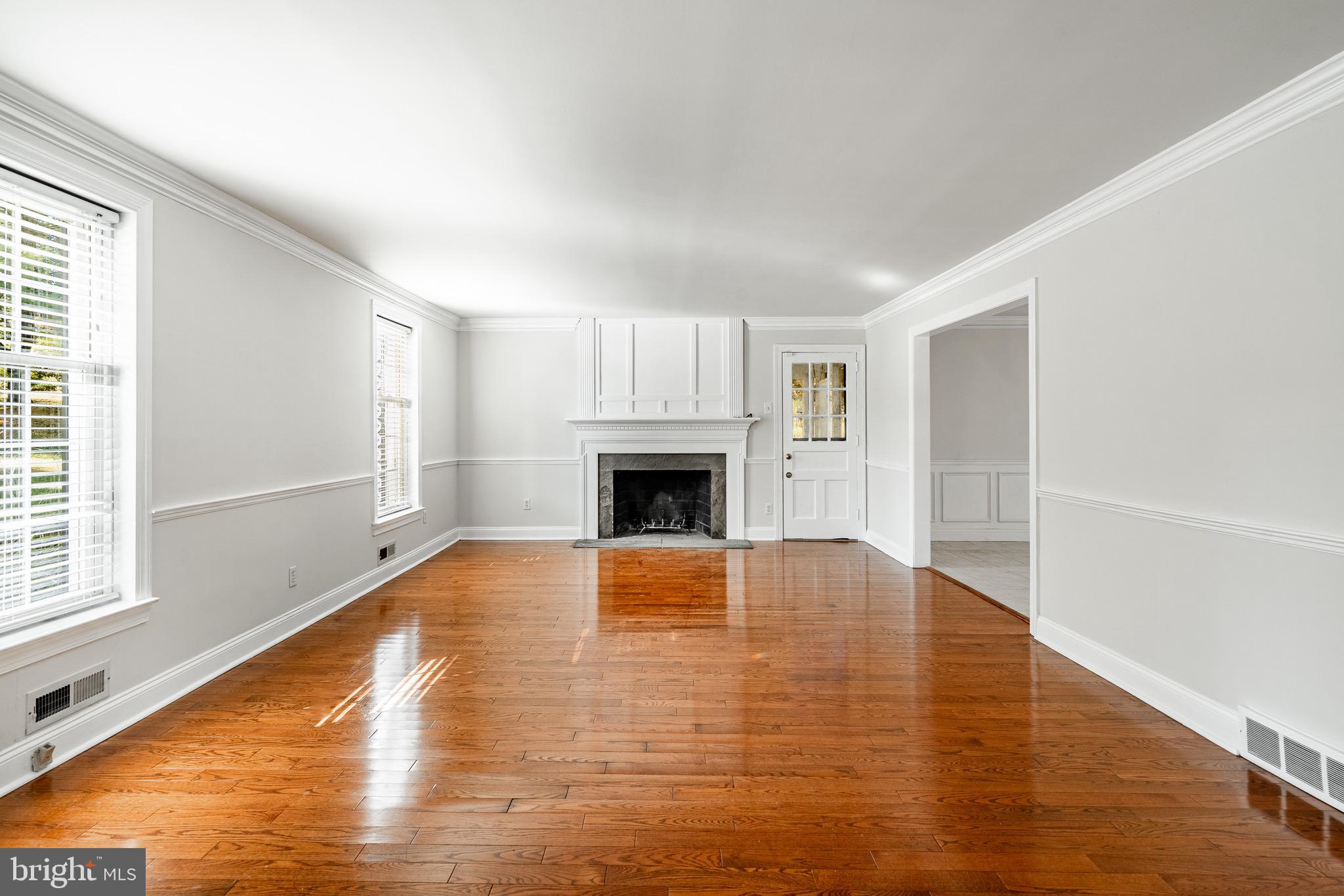 657 Walker Road Wayne, PA 19087 - Photo 19 of 66 a view of empty room with wooden floor and fireplace