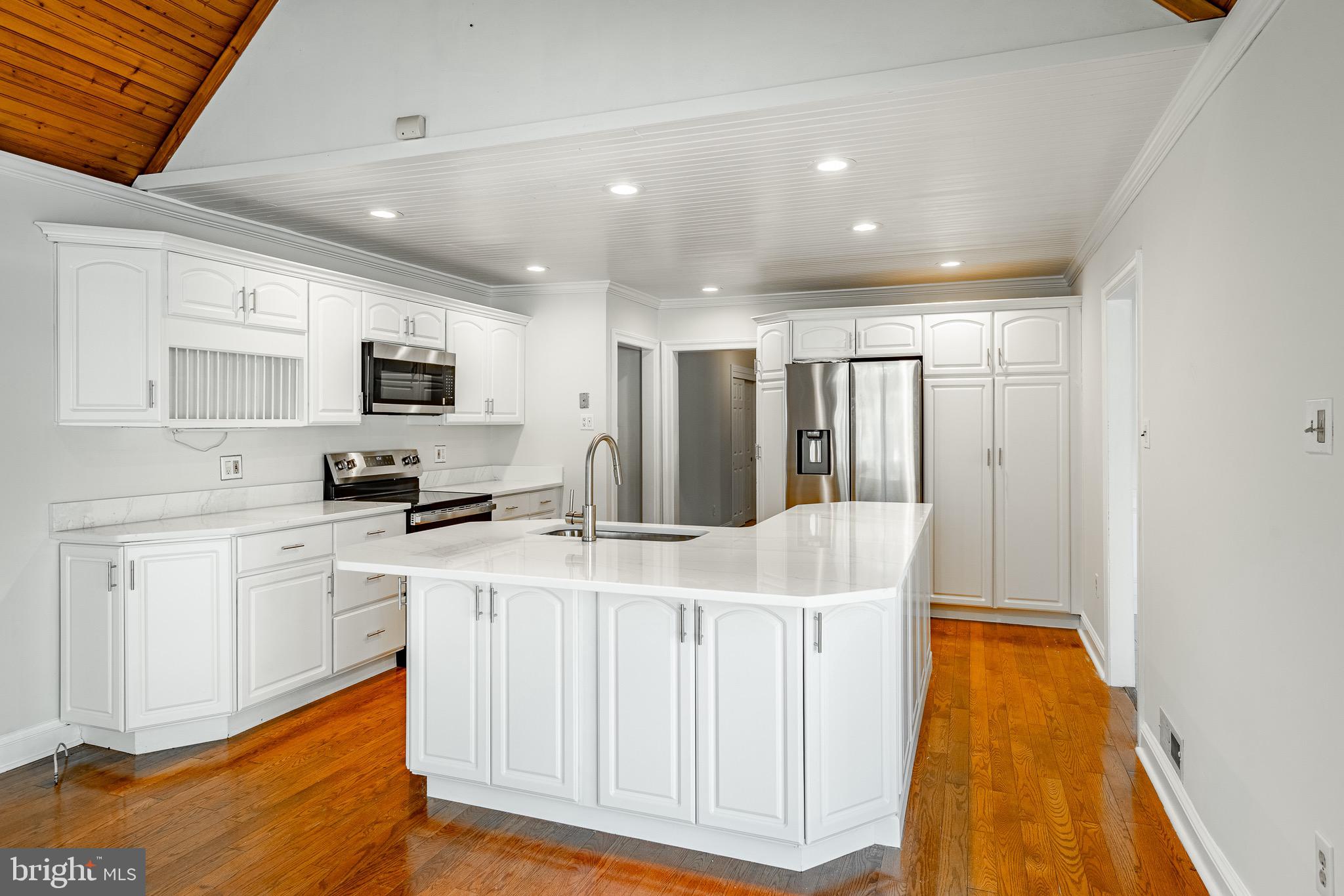 657 Walker Road Wayne, PA 19087 - Photo 26 of 66 a kitchen with stainless steel appliances granite countertop a stove a sink a refrigerator white cabinets and a refrigerator