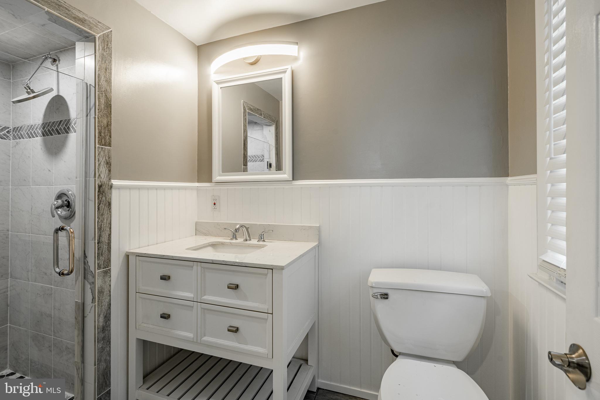 657 Walker Road Wayne, PA 19087 - Photo 37 of 66 a bathroom with a toilet a sink and mirror