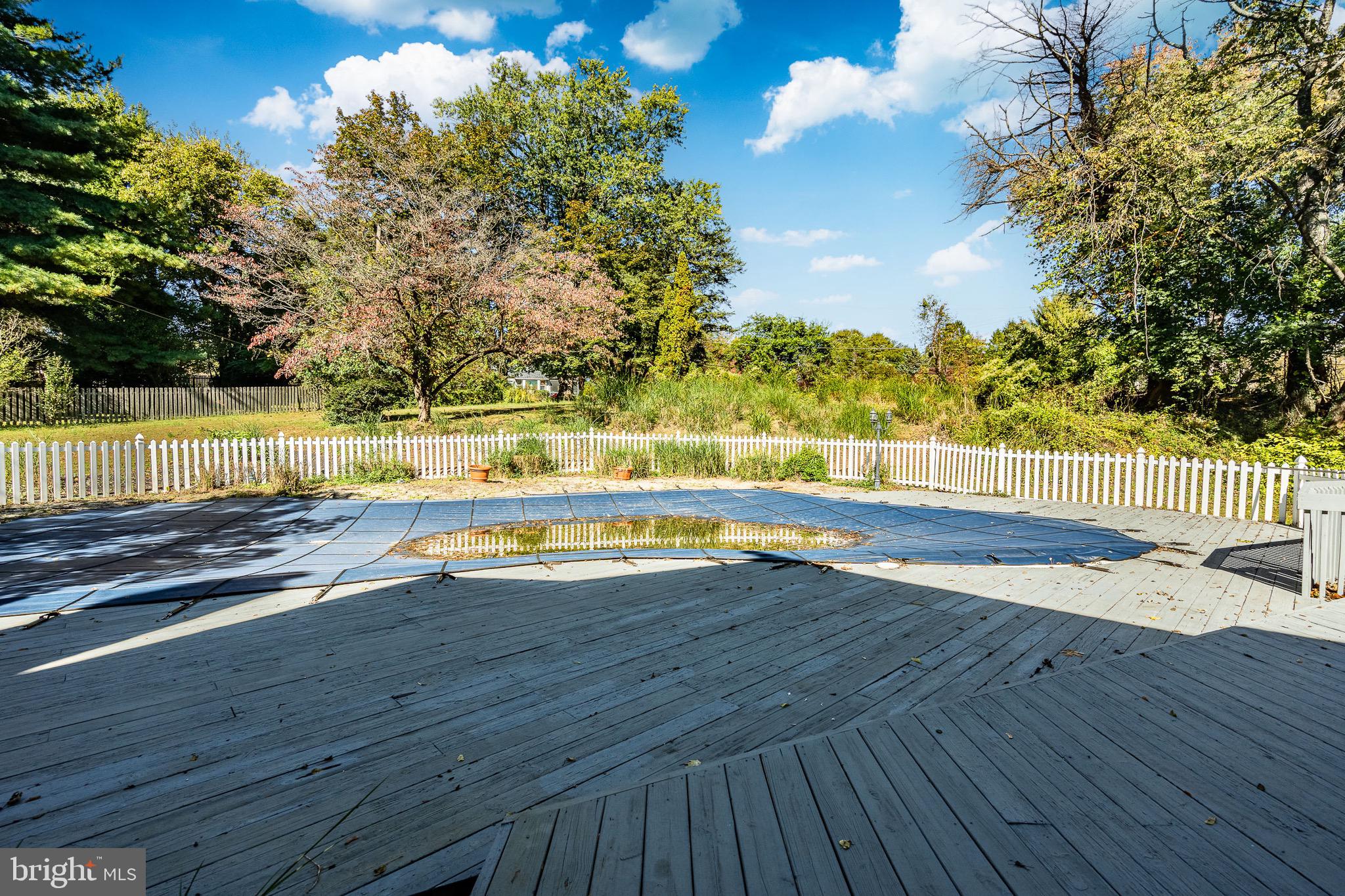 657 Walker Road Wayne, PA 19087 - Photo 49 of 66 a view of a swimming pool with an outdoor space and seating area