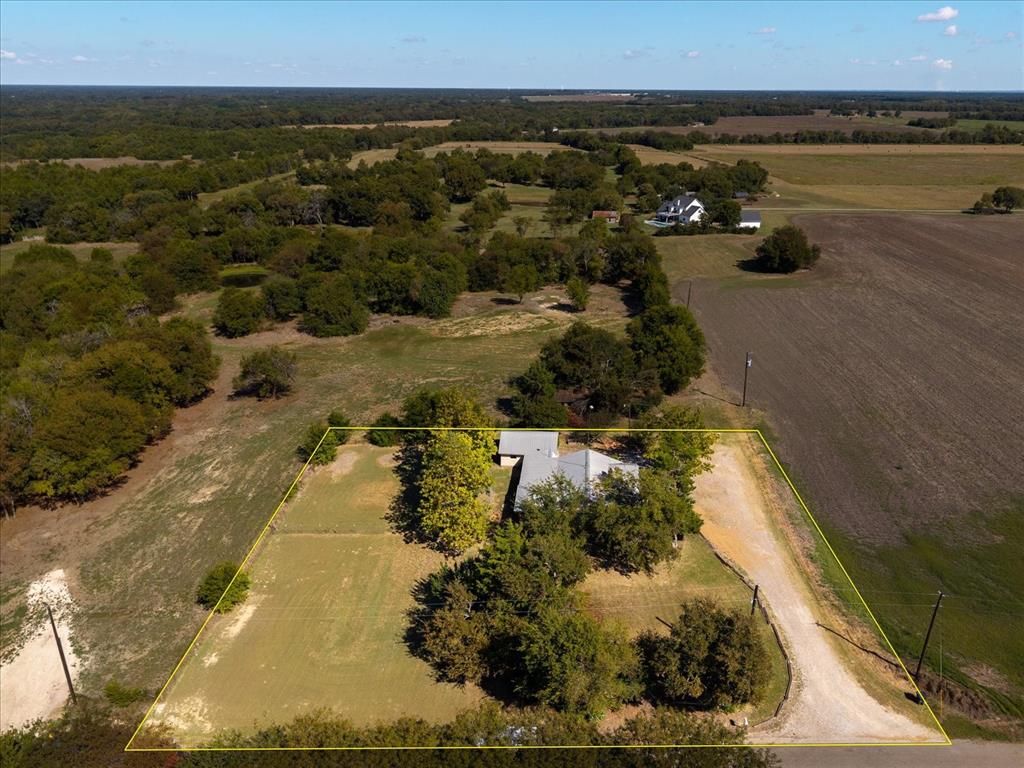 an aerial view of a house with a yard