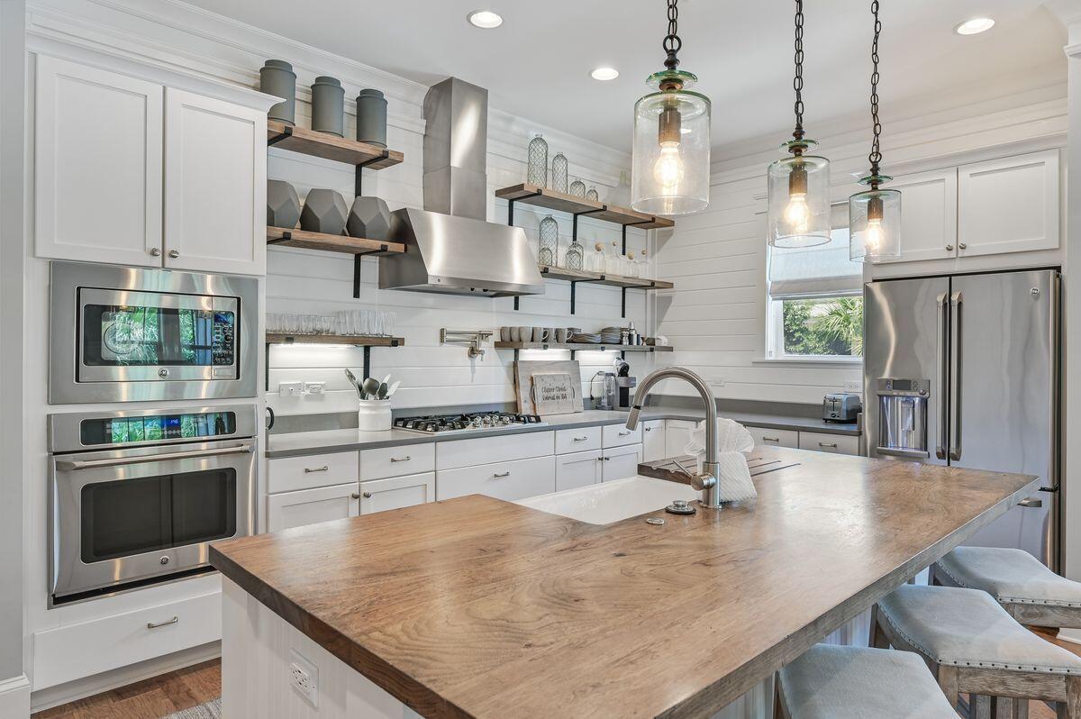 89 Clipper Street Inlet Beach, FL 32461 - Photo 11 of 49 a kitchen with stainless steel appliances granite countertop a sink counter space and cabinets
