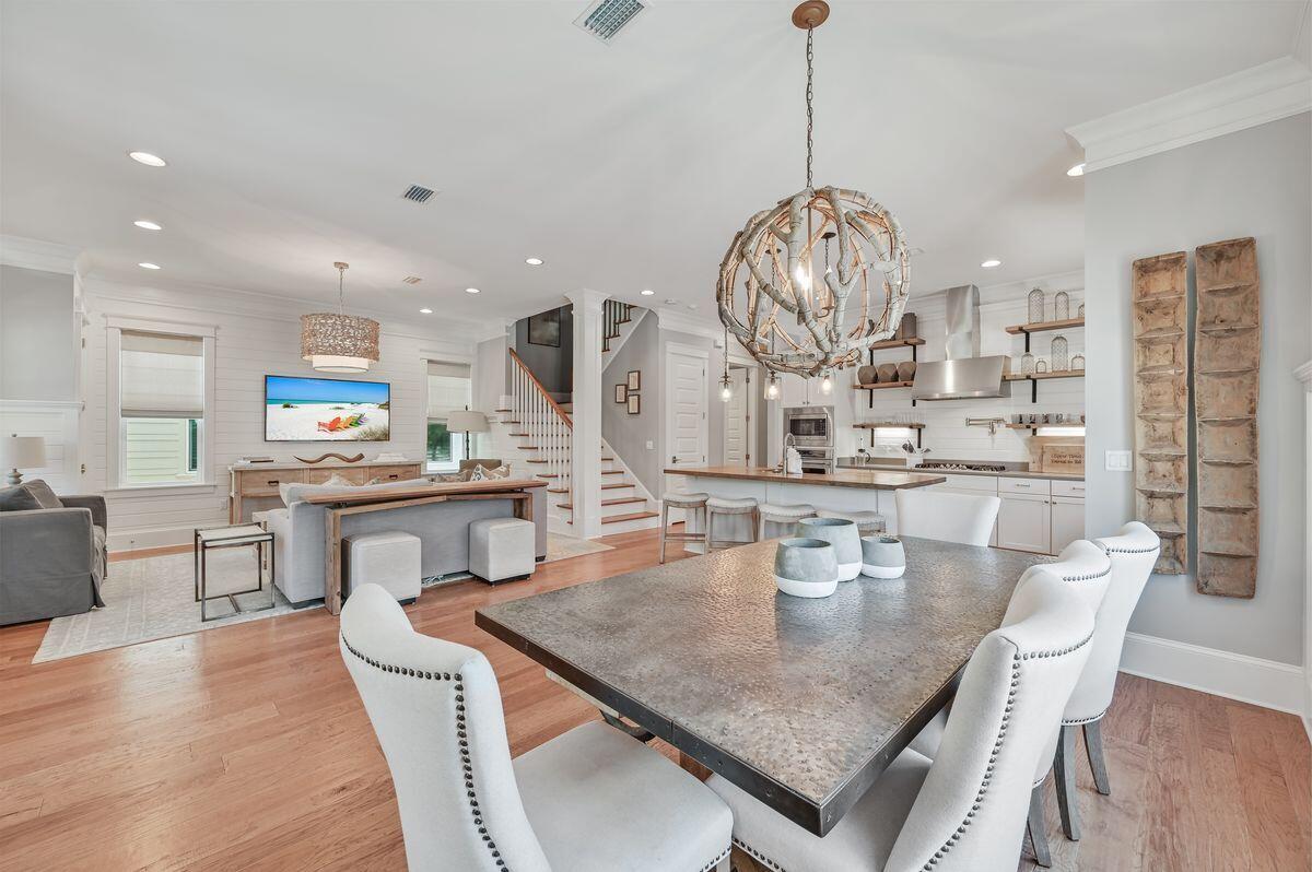 89 Clipper Street Inlet Beach, FL 32461 - Photo 13 of 49 a view of a dining room with furniture a kitchen and chandelier