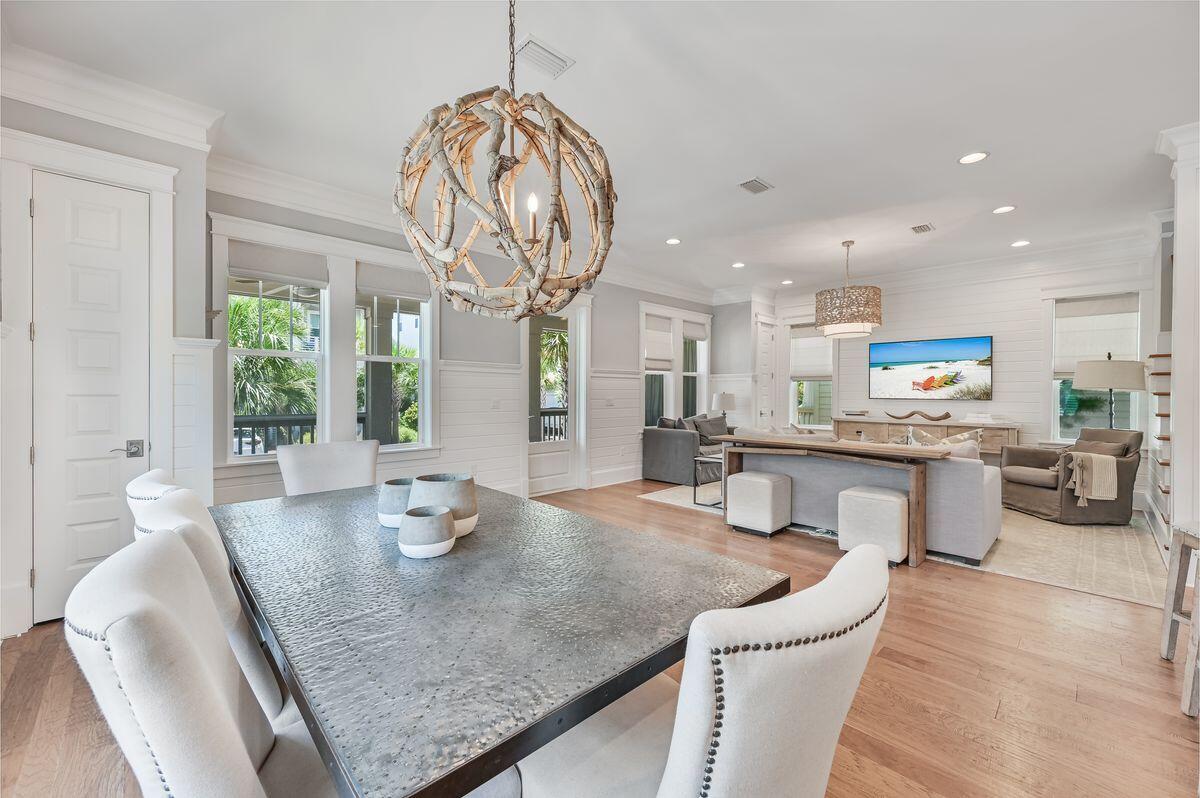 89 Clipper Street Inlet Beach, FL 32461 - Photo 14 of 49 a kitchen with stainless steel appliances granite countertop a stove a table and chairs in it