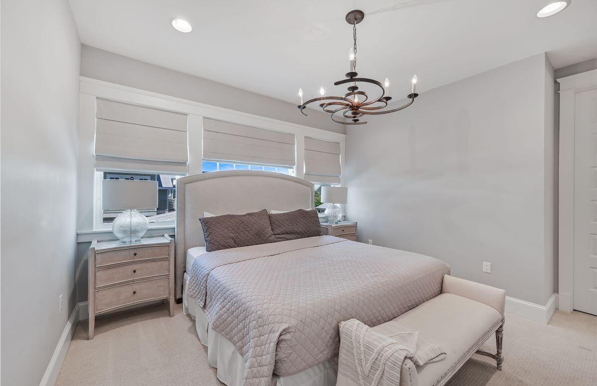89 Clipper Street Inlet Beach, FL 32461 - Photo 27 of 49 a bedroom with a bed and a chandelier