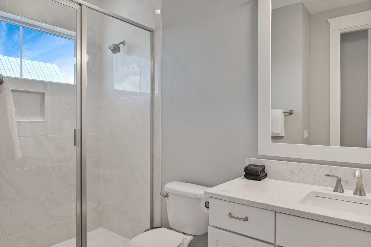 89 Clipper Street Inlet Beach, FL 32461 - Photo 29 of 49 a bathroom with a toilet sink vanity and mirror