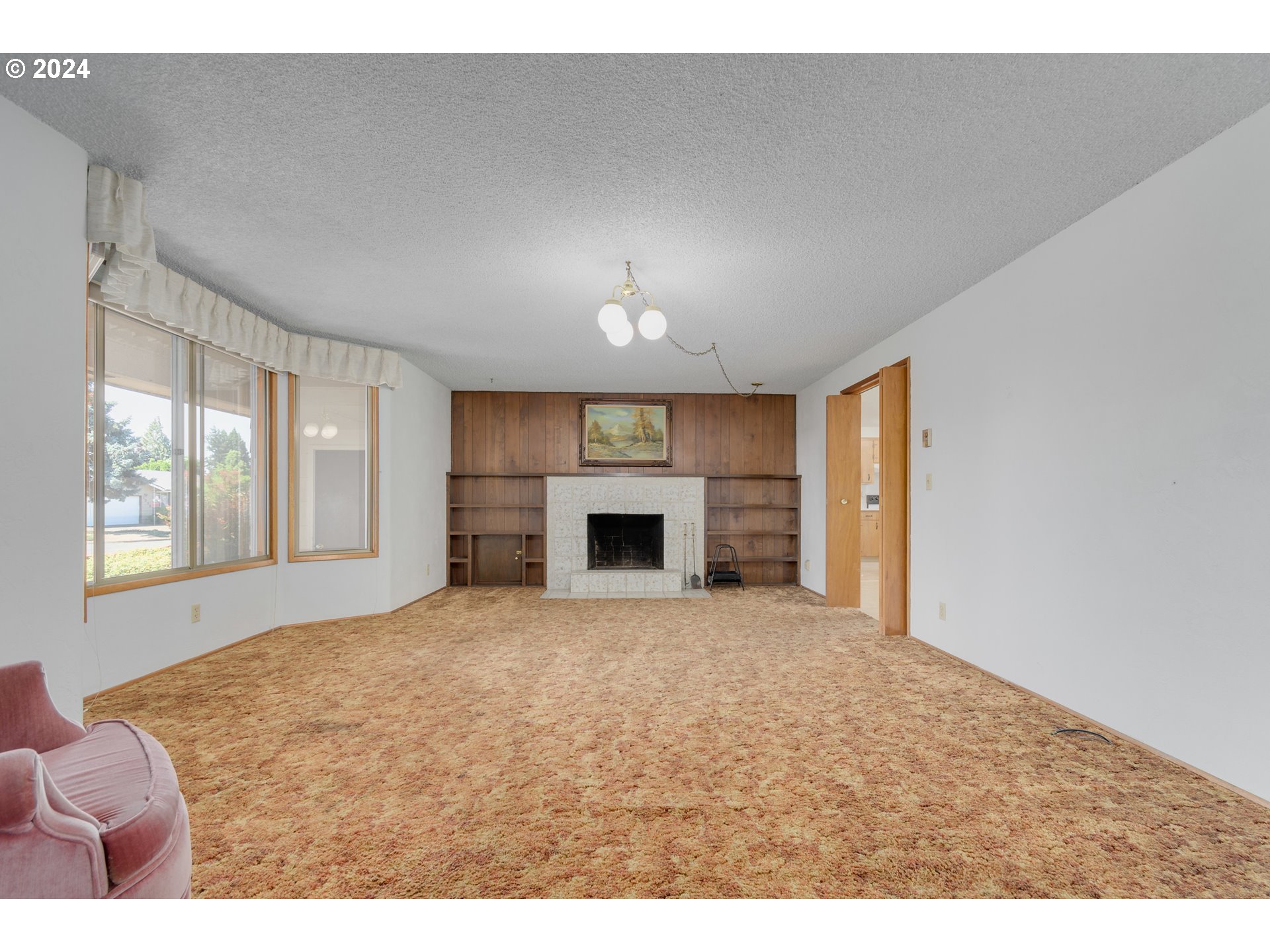 1816 Yolanda Avenue Springfield, OR 97477 - Photo 5 of 48 a view of an empty room with a fireplace and a window