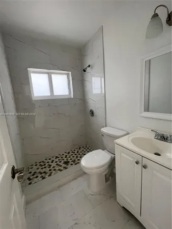 a bathroom with a sink toilet and shower