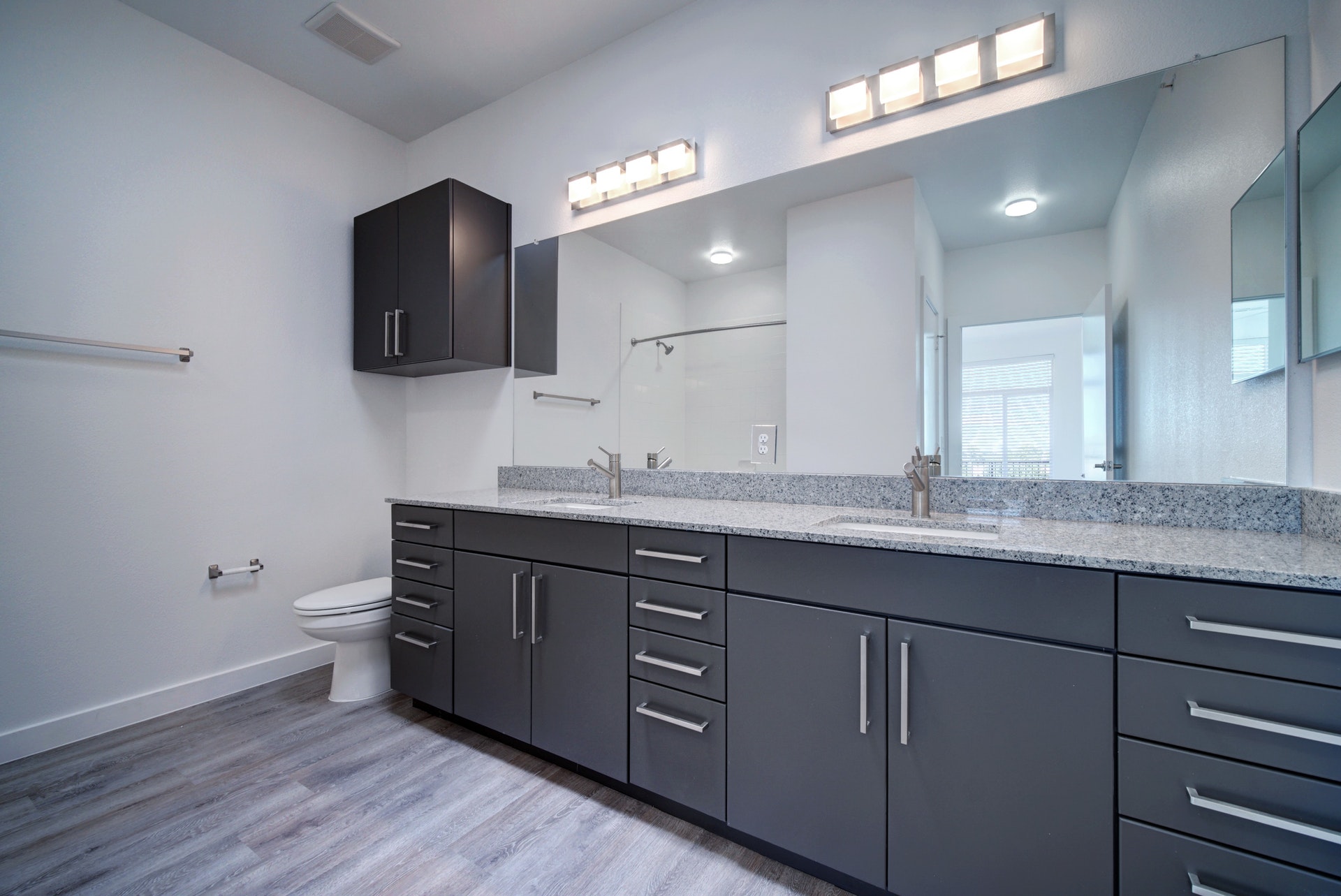 13130 Pond Springs Road, Unit 3214 Austin, TX 78729 - Photo 24 of 40 Bathroom featuring double vanity, light wood-style floors, and walk in shower