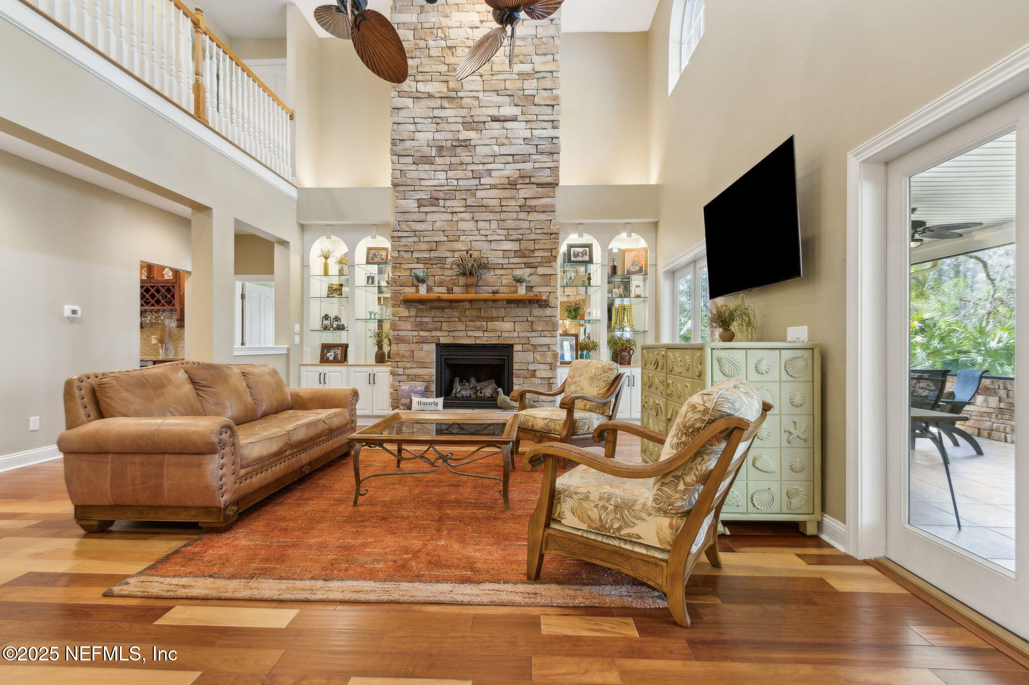 96197 Brady Point Road Fernandina Beach, FL 32034 - Photo 14 of 40 a living room with furniture a flat screen tv and a fireplace