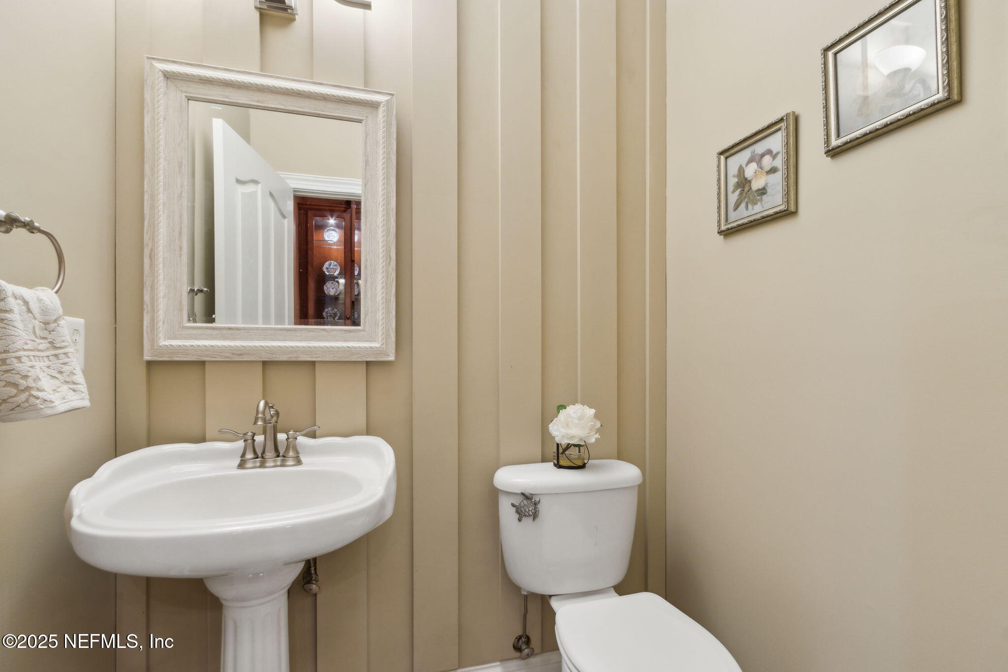 96197 Brady Point Road Fernandina Beach, FL 32034 - Photo 17 of 40 a bathroom with a toilet sink and mirror
