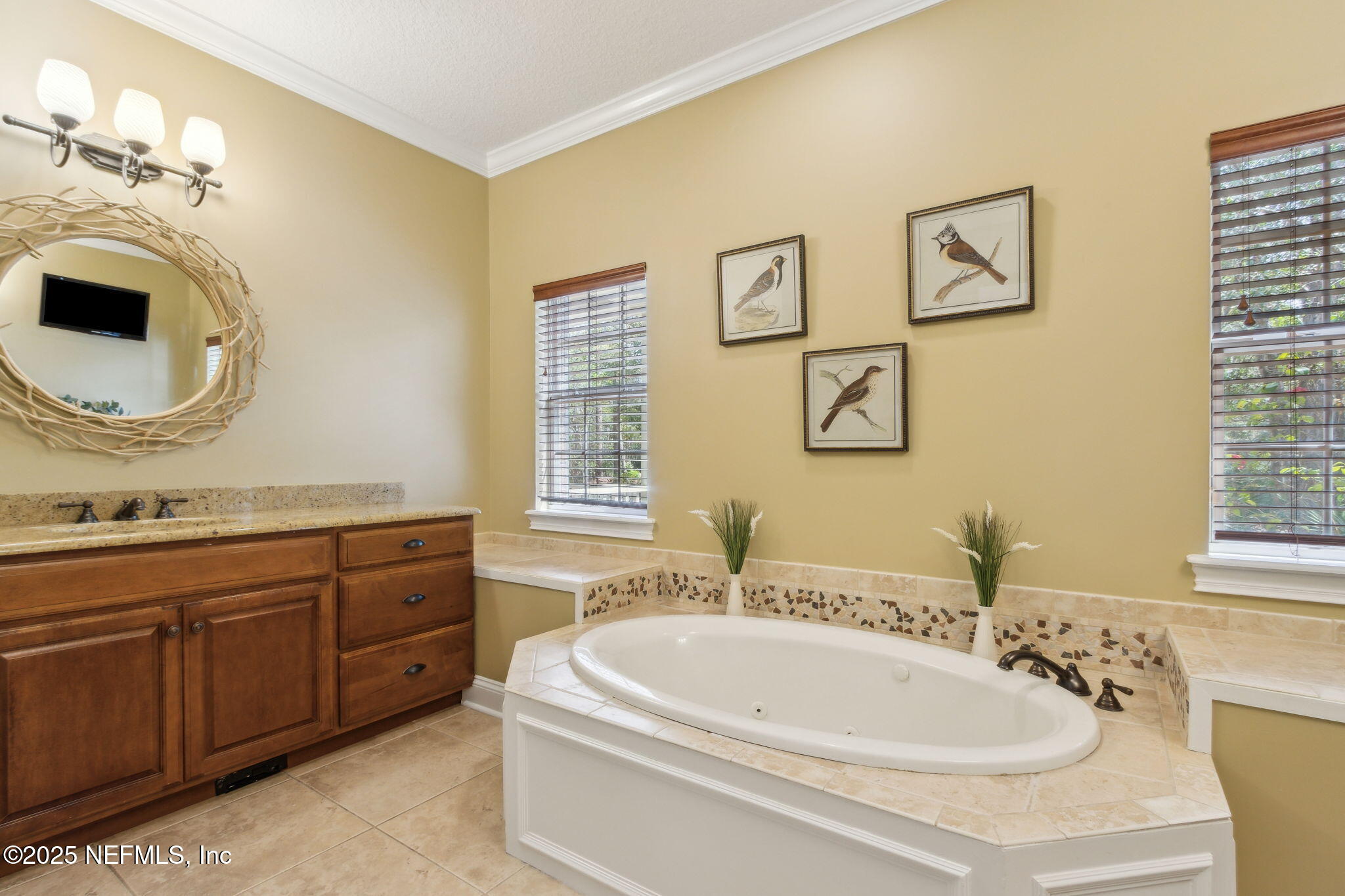 96197 Brady Point Road Fernandina Beach, FL 32034 - Photo 19 of 40 a bathroom with a tub sink and mirror
