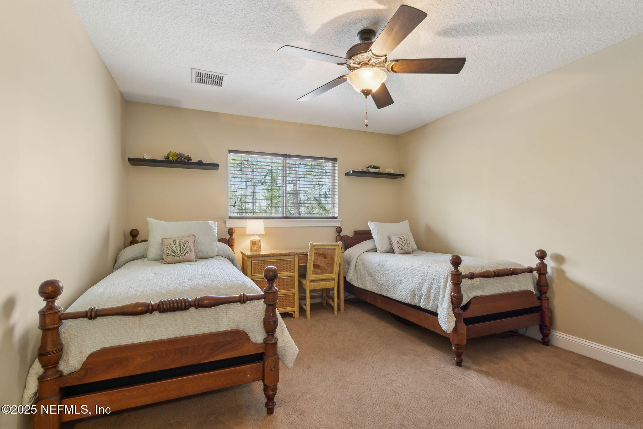 96197 Brady Point Road Fernandina Beach, FL 32034 - Photo 24 of 40 a bedroom with a bed and a chandelier