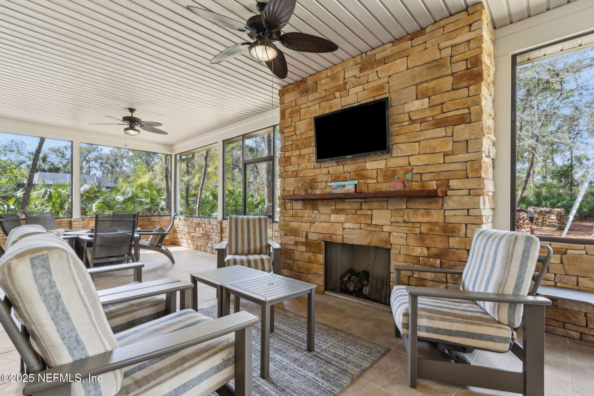 96197 Brady Point Road Fernandina Beach, FL 32034 - Photo 31 of 40 a living room with furniture a flat screen tv and a fireplace