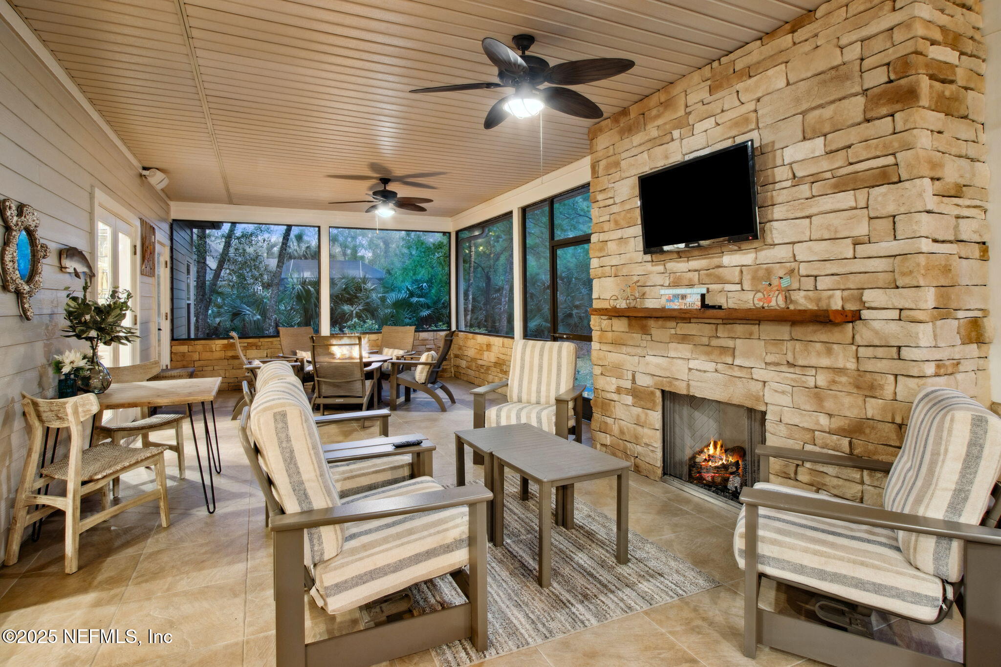 96197 Brady Point Road Fernandina Beach, FL 32034 - Photo 33 of 40 a living room with fireplace furniture and a flat screen tv