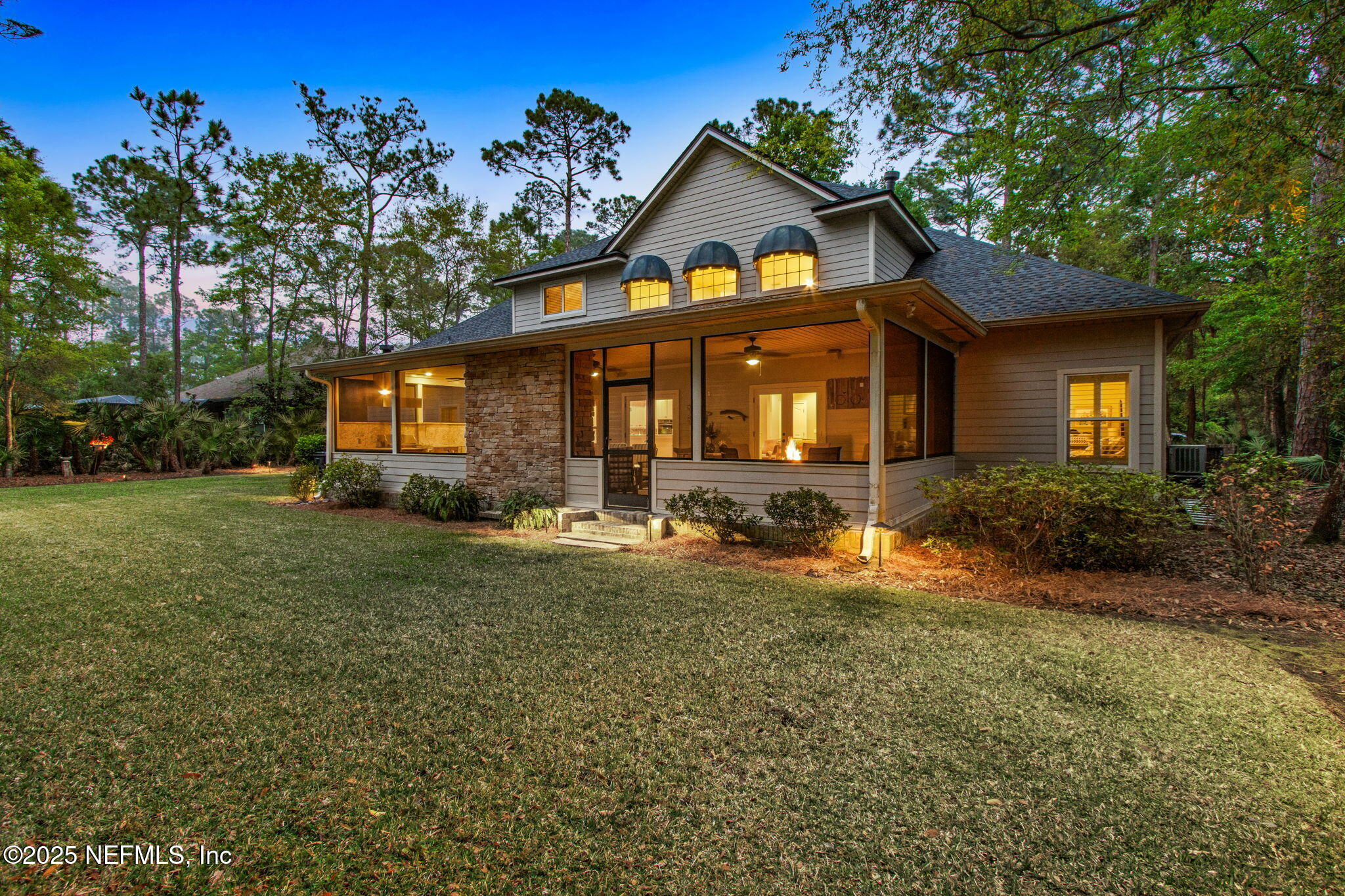 96197 Brady Point Road Fernandina Beach, FL 32034 - Photo 34 of 40 a front view of a house with garden