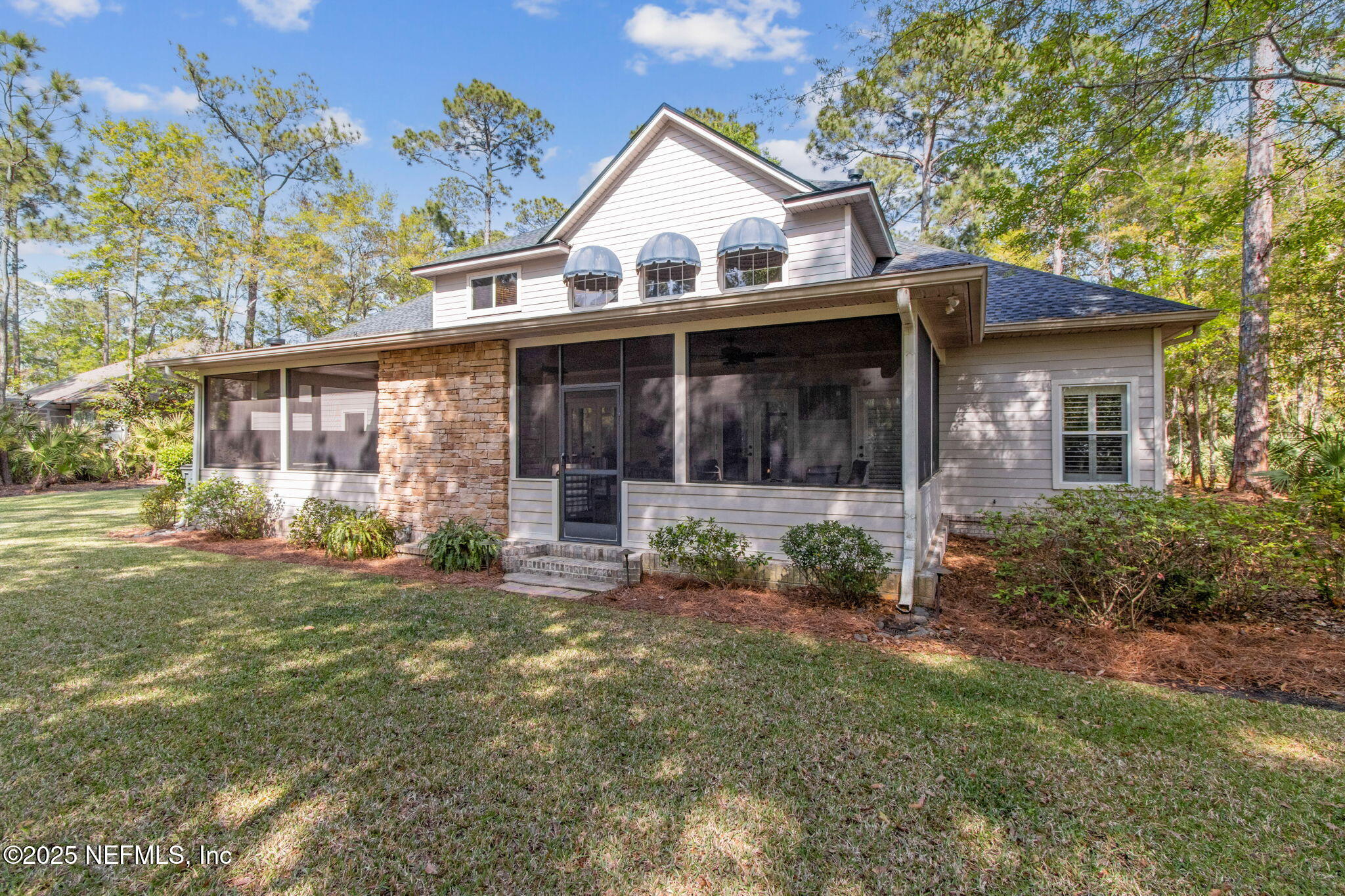 96197 Brady Point Road Fernandina Beach, FL 32034 - Photo 36 of 40 a view of a white house with a big yard and large trees