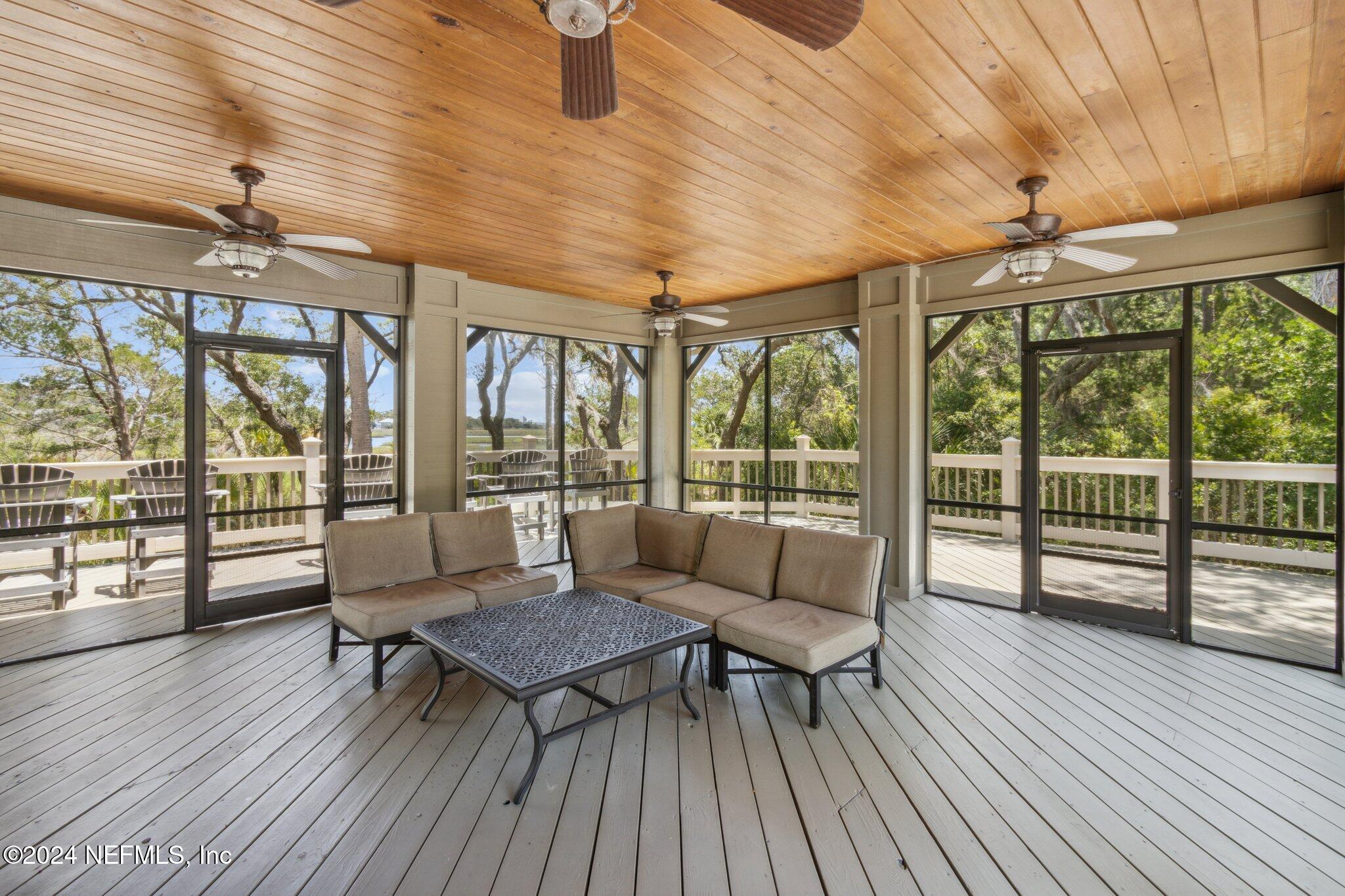96197 Brady Point Road Fernandina Beach, FL 32034 - Photo 40 of 40 a living room with furniture and a floor to ceiling window