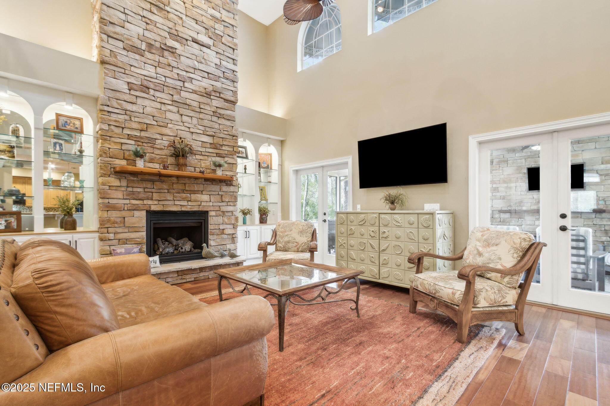 96197 Brady Point Road Fernandina Beach, FL 32034 - Photo 4 of 40 a living room with furniture a fireplace and a flat screen tv