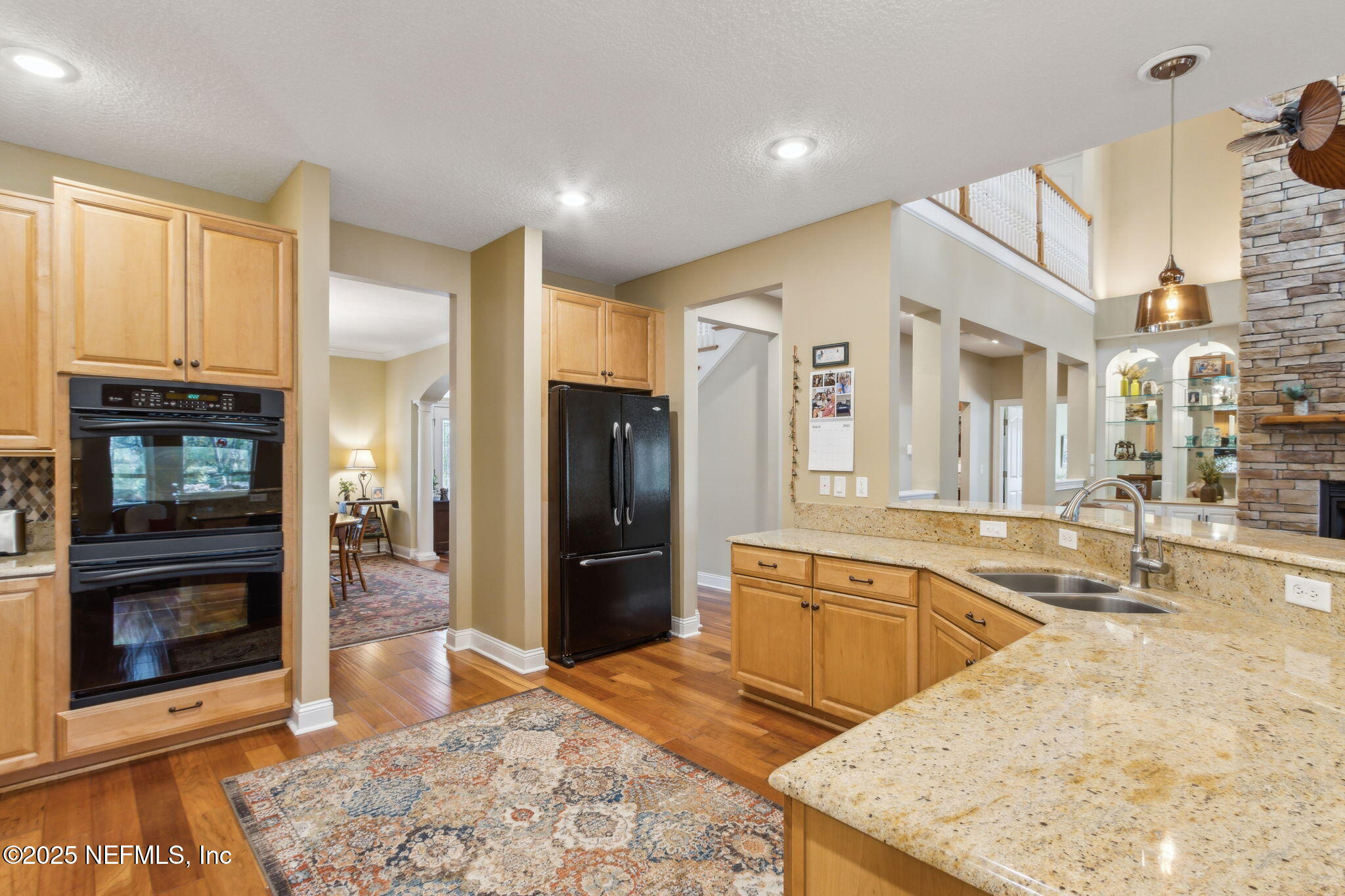 96197 Brady Point Road Fernandina Beach, FL 32034 - Photo 5 of 40 a large kitchen with stainless steel appliances kitchen island granite countertop a refrigerator and a stove top oven