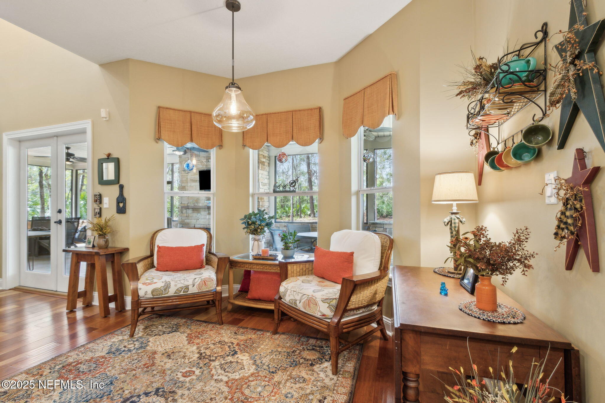 96197 Brady Point Road Fernandina Beach, FL 32034 - Photo 8 of 40 a dining room with furniture a chandelier and wooden floor