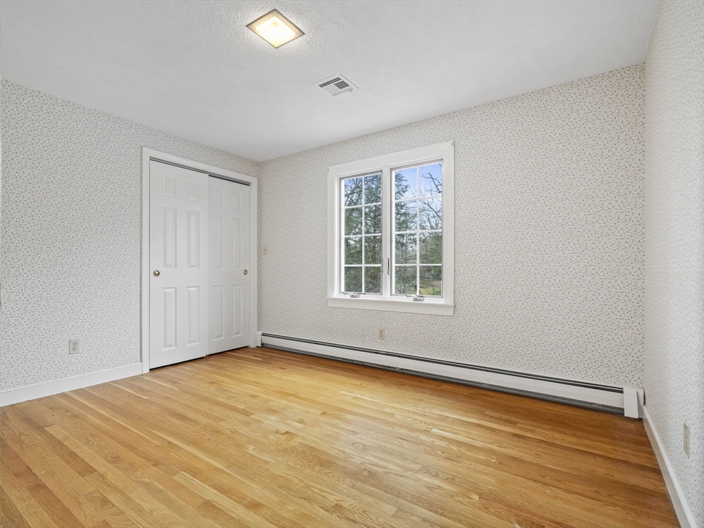 40 Audubon Road Wellesley, MA 02481 - Photo 13 of 21 an empty room with wooden floor and windows