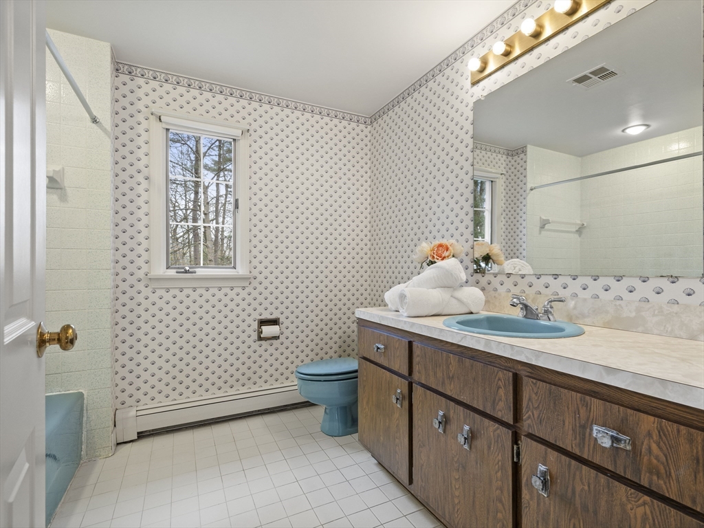 40 Audubon Road Wellesley, MA 02481 - Photo 15 of 21 a bathroom with a sink toilet and mirror