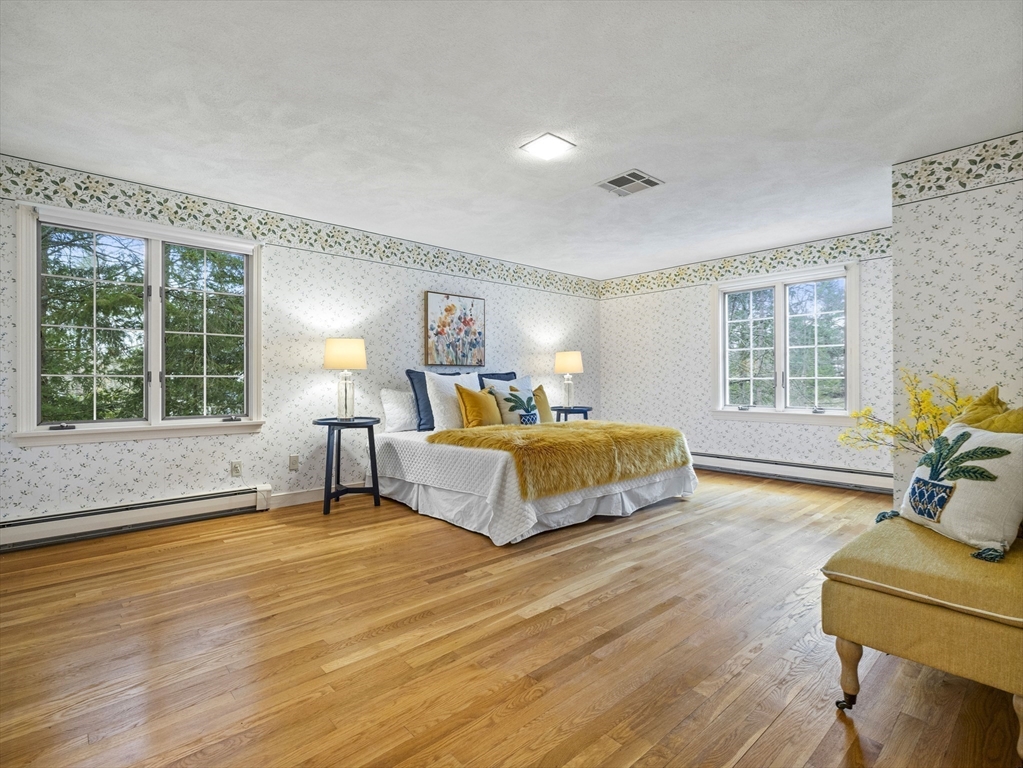 40 Audubon Road Wellesley, MA 02481 - Photo 17 of 21 a spacious bedroom with a bed and wooden floor