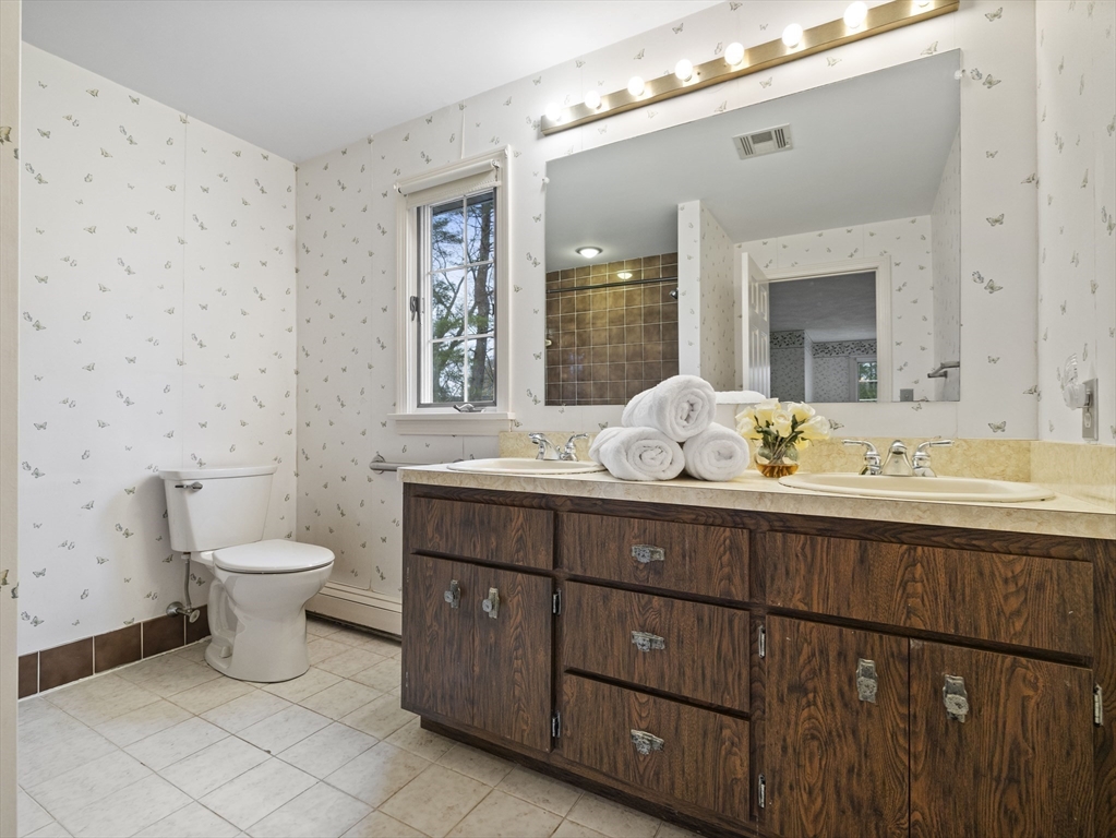 40 Audubon Road Wellesley, MA 02481 - Photo 18 of 21 a bathroom with a toilet a sink and mirror