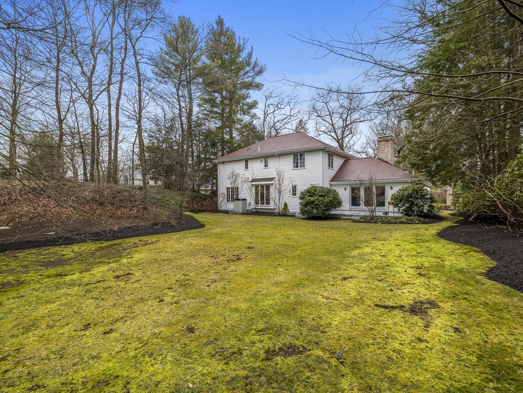 40 Audubon Road Wellesley, MA 02481 - Photo 21 of 21 a white house sitting in middle of forest